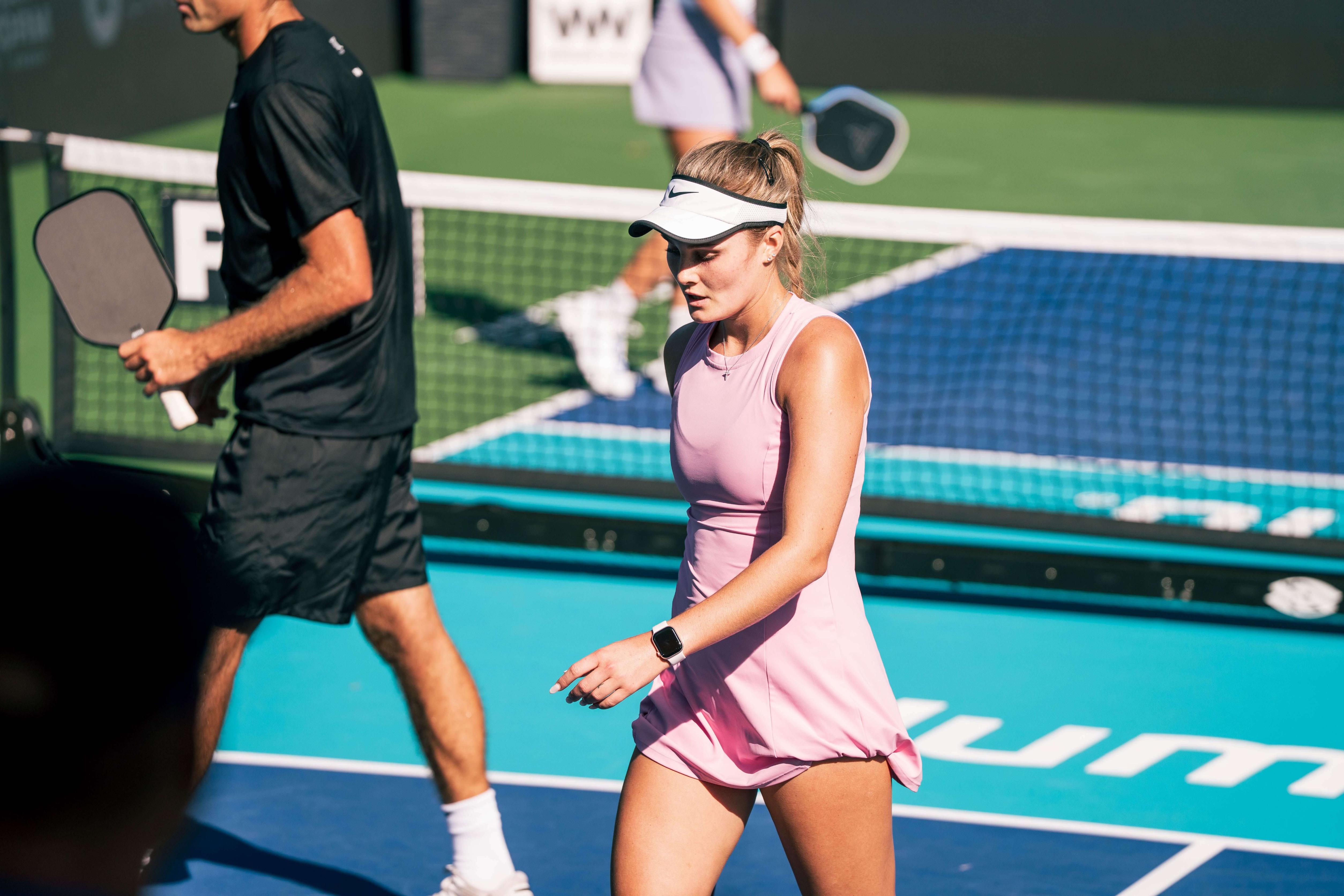 Sleeth in a high neck fitted pink dress